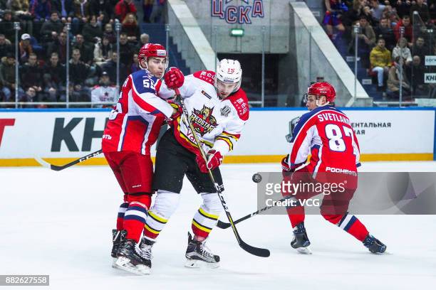 Brendan O'Donnell of HC Kunlun Red Star, Andrei Svetlakov and Bogdan Kiselevich of HC CSKA Moscow vie for the puck during the 2017/18 Kontinental...