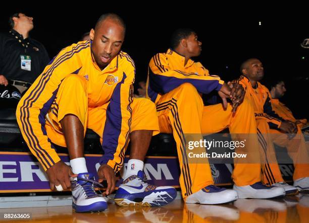 Kobe Bryant of the Los Angeles Lakers ties his shoes prior to Game One of the 2009 NBA Finals against the Orlando Magic at Staples Center on June 4,...