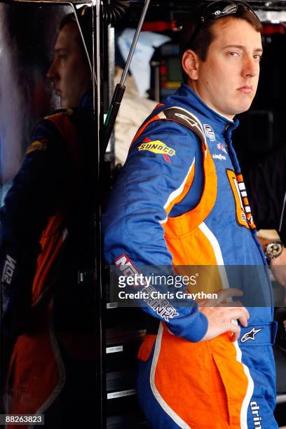 Kyle Bush, driver of the NOS Toyota stands in the garage area during practice for the NASCAR Nationwide Series Federated Auto Parts 300 at the...