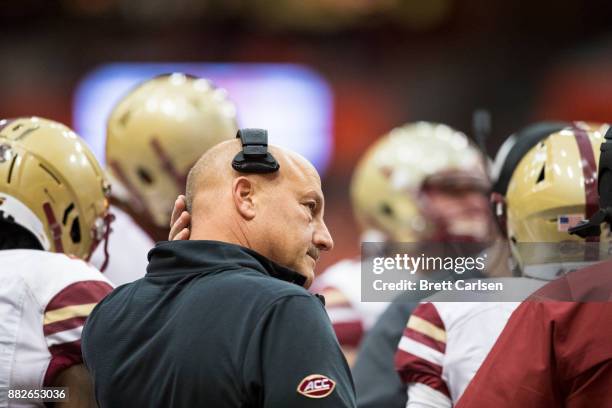 Head coach Steve Addazio of the Boston College Eagles participates in a time out huddle during the game against the Syracuse Orange at the Carrier...