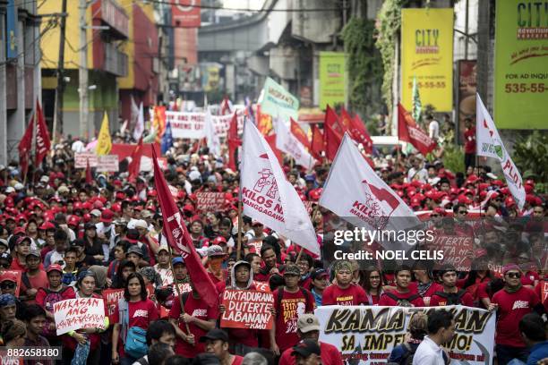 Activists march to the Malacanang palace during an anti-Duterte protest in Manila on November 30 denouncing the government's crackdown of activists...
