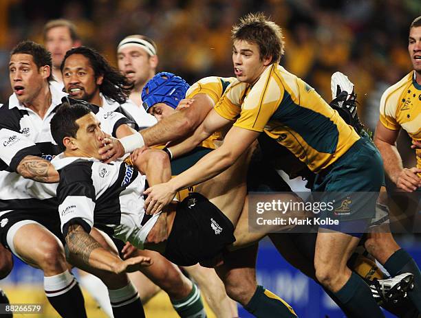 Sonny Bill Williams of the Barbarians is tackled by Nathan Sharpe and Drew Mitchell of the Wallabies during the Nick Shehadie Cup match between the...