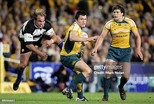 Phil Waugh of the Barbarians attempts a tackled on Adam Ashley-Cooper of the Wallabies as Luke Burgess looks on during the Nick Shehadie Cup match...