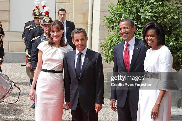 Carla Bruni Sarkozy, French President Nicolas Sarkozy, US President Barack Obama and his wife Michelle Obama review troops at Caen prefecture on June...