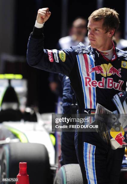 Red Bull's German driver Sebastian Vettel celebrates in the parc ferme of the Istanbul Park circuit on June 6, 2009 in Istanbul, after the qualifying...