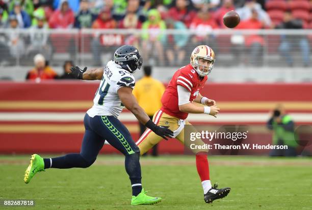 Beathard of the San Francisco 49ers gets his pass off under pressure from Bobby Wagner of the Seattle Seahawks during their NFL football game at...