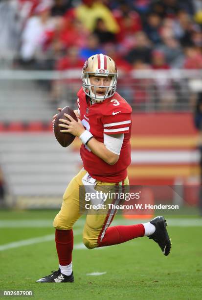 Beathard of the San Francisco 49ers rolls out to pass against the Seattle Seahawks during their NFL football game at Levi's Stadium on November 26,...