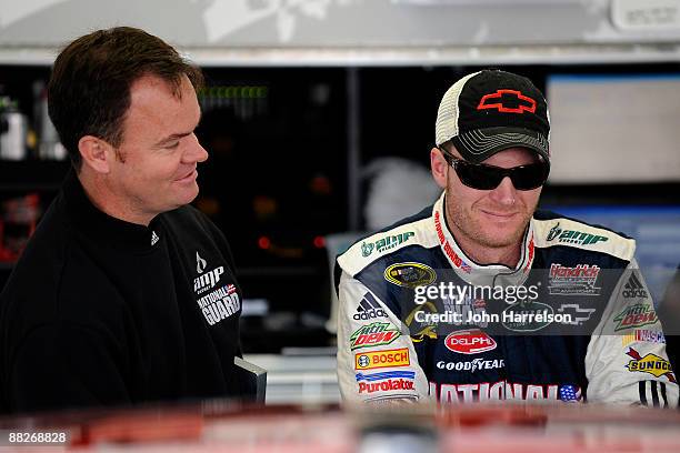 Dale Earnhardt Jr. Driver of the National Guard/AMP Energy Chevrolet talks with Crew Chief Lance McGrew before practice for the NASCAR Sprint Cup...