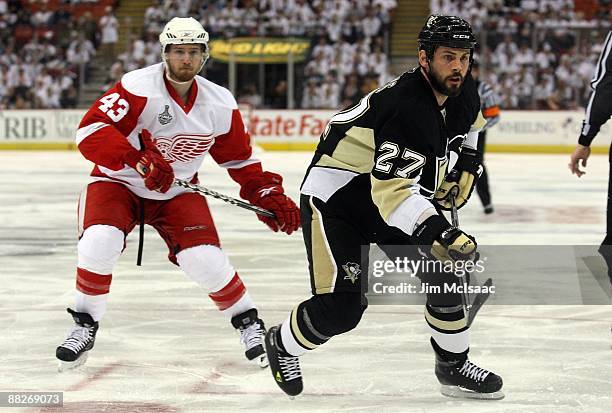 Craig Adams of the Pittsburgh Penguins skates against Darren Helm of the Detroit Red Wings during Game Four of the 2009 NHL Stanley Cup Finals on...