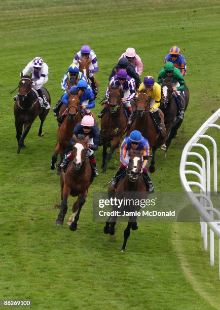 Horses and jockeys round Tattenham Corner with eventual winner Mick Kinane and Sea The Stars poised for the run in during the Investec Derby run at...