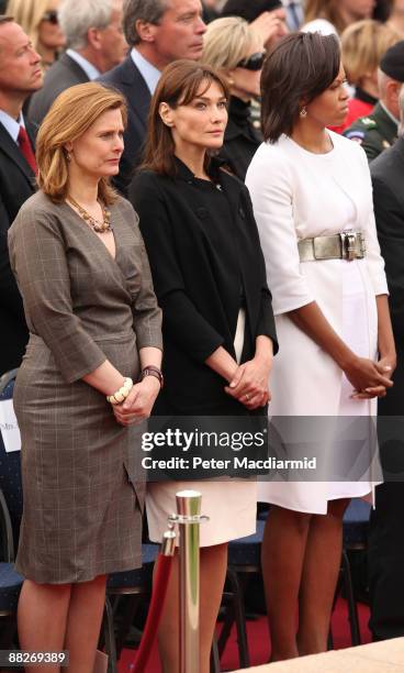 First Lady Michelle Obama stands with Carla Bruni-Sarkozy and Sarah Brown during a memorial service at the Normandy American Cemetery on June 6, 2009...