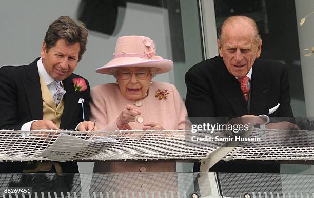 Queen Elizabeth II and Prince Philip, Duke of Edinburgh watch the Derby from the Royal balcony on June 6, 2009 in Epsom, England.