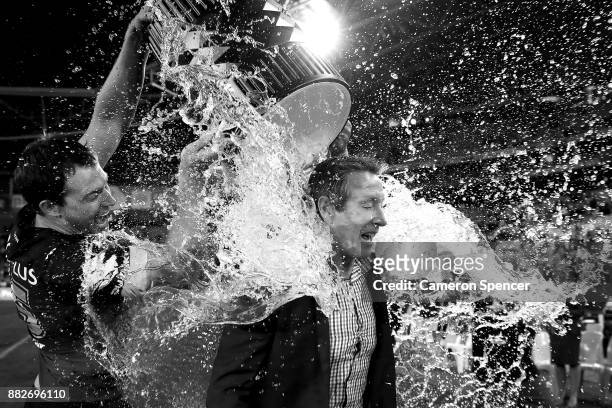Storm coach Craig Bellamy is drenched with water after winning the 2017 NRL Grand Final match between the Melbourne Storm and the North Queensland...