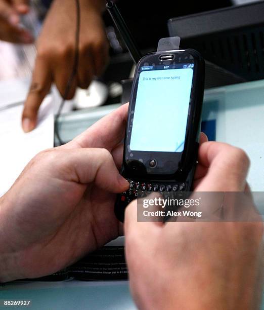 David Schloss of Bethesda, Maryland, tries out his new Palm Pre smartphone at a Sprint store June 6, 2009 in Washington, DC. The latest release from...