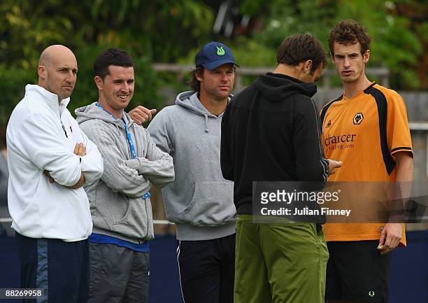 Andy Murray of Great Britain stands with coach Miles Maclagan, Jez Green and Ross Hutchins after a practice session at Queens Club on June 6, 2009 in...