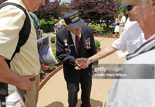 Veteran Jack Sherertz of Charlotte, North Carolina, who participated in battles at Pearl Harbor, Midway and Normandy on D-Day, talks to visitors at...