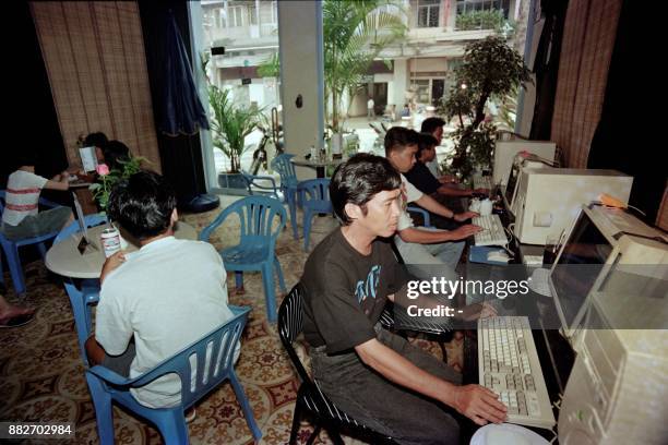 Men use computers at Tam Tam cafe which bills itself as Vietnam's first cyber cafe on September 14, 1996 in Ho Chi Minh City.