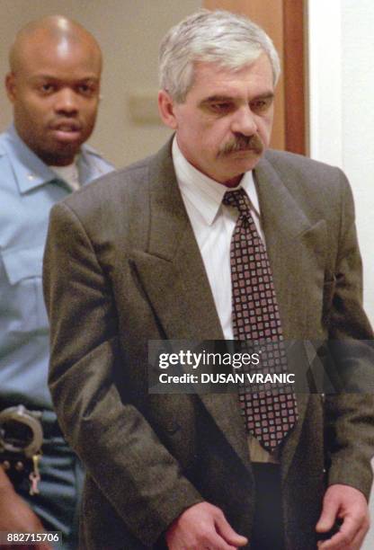 File picture dated 19 January 1998 of Croatian Serb Slavko Dokmanovic arriving in a courtroom to stand trial before the United Nations War Crimes...