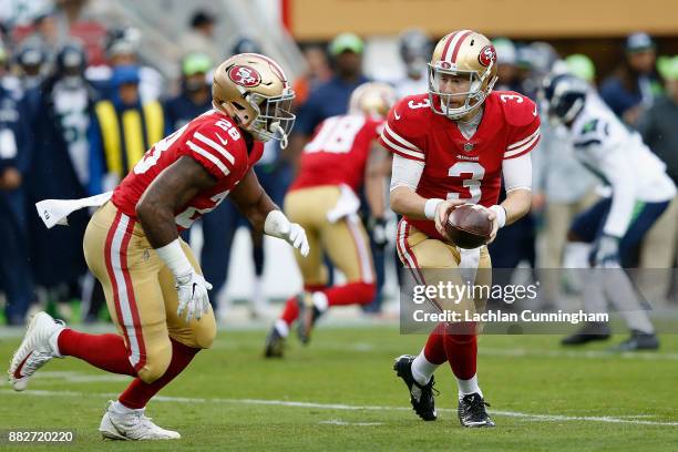 Quarterback C.J. Beathard looks to hand off to running back Carlos Hyde of the San Francisco 49ers against the Seattle Seahawks at Levi's Stadium on...