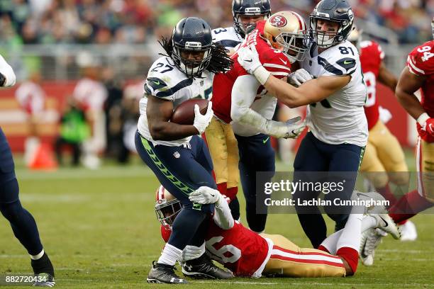 Eddie Lacy of the Seattle Seahawks is tackled by Dontae Johnson of the San Francisco 49ers at Levi's Stadium on November 26, 2017 in Santa Clara,...