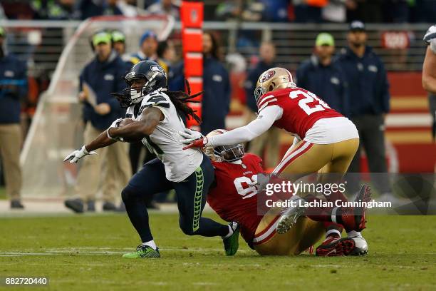McKissic of the Seattle Seahawks evades a tackle by Earl Mitchell and Leon Hall of the San Francisco 49ers at Levi's Stadium on November 26, 2017 in...