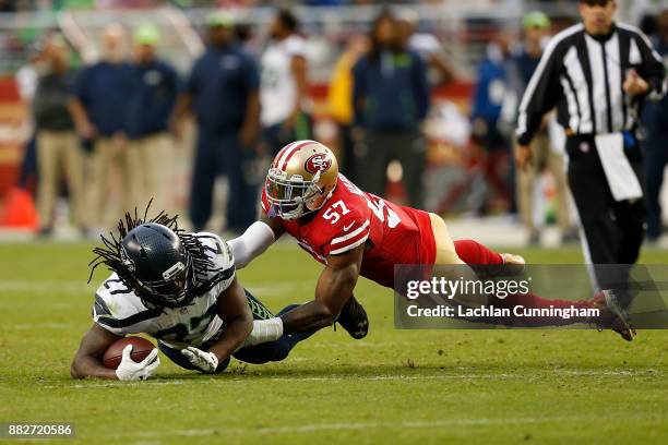 Eddie Lacy of the Seattle Seahawks is tackled by Eli Harold of the San Francisco 49ers at Levi's Stadium on November 26, 2017 in Santa Clara,...