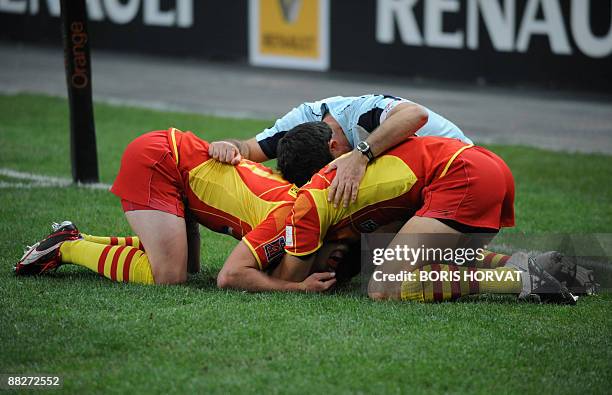 Perpignan trainer celebrates with players at the end of their French Top 14 rugby union final match Clermont vs. Perpignan on June 6, 2009 at the...