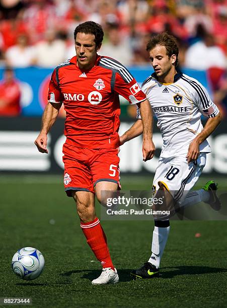 Defender Kevin Harmse of the Toronto FC is chased by forward Mike Magee of the Los Angeles Galaxy during the match at BMO Field on June 6, 2009 in...