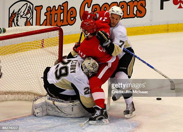 Dan Cleary of the Detroit Red Wings takes a shot against Mark Eaton and goaltender Marc-Andre Fleury of the Pittsburgh Penguins during Game Five of...