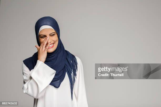 smiling muslim woman wearing hijab - middle east stock pictures, royalty-free photos & images