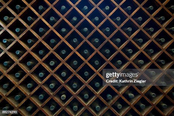 wooden rack with wine bottles - wine rack stock pictures, royalty-free photos & images