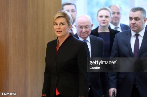 Croatian President Kolinda Grabar-Kitarovic and her advisors arrive to address a press conference in Zagreb on November 30 a day after the suicide of...