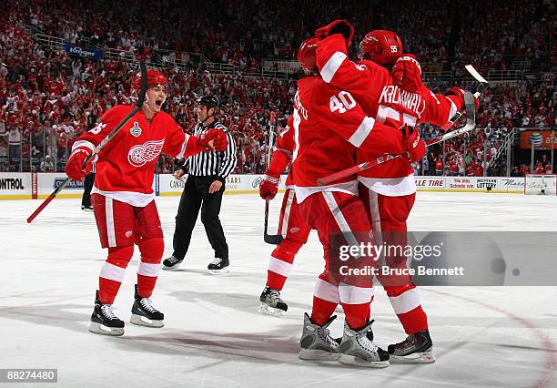 Niklas Kronwall of the Detroit Red Wings celebrates with Jiri Hudler and Henrik Zetterberg after scoring a goal in the second period against the...