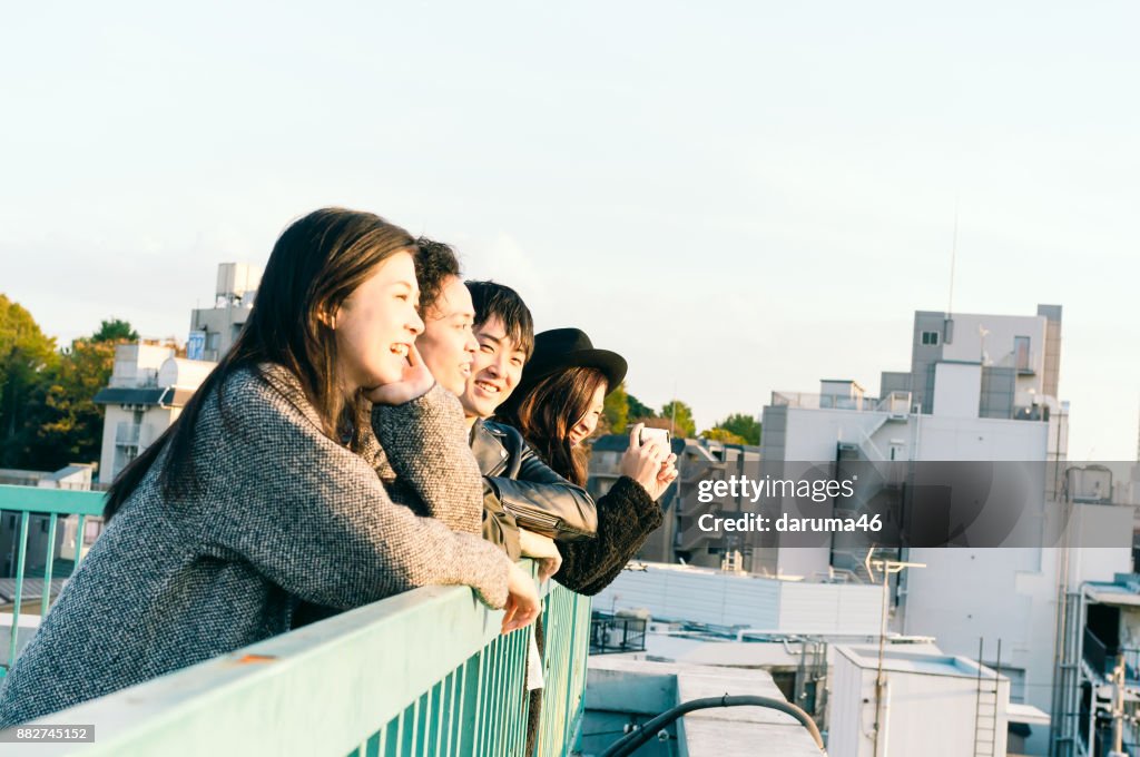 Group of friends having fun on urban rooftop