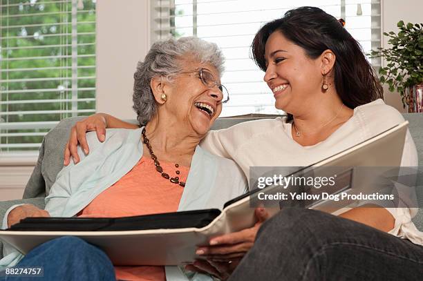 adult child sharing moment with senior mom - family caregiver stock pictures, royalty-free photos & images