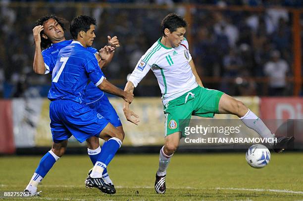 Mexico's Guillermo Franco vies for the ball with El Salvador's Ramon Sanchez and Alexander Escobar during their FIFA World Cup South Africa-2010...