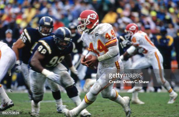 Harvey Williams of the Kansas City Chiefs rushes gainst the San Diego Chargers in the AFC Wild Card game played at Jack Murphy Stadium circa 1992 in...