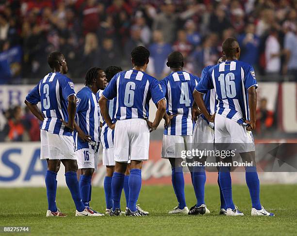 Maynor Figueroa, Walter Martinez, Mario Beata, Hendry Thomas and Georgie Welcome of Honduras watch as members of the United States celebrate a win...