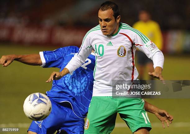 Salvadorean Alexander Escobar vies the ball with Mexican Cuautemoch Blanco during their FIFA World Cup South Africa-2010 qualifier on June 6, 2009 at...