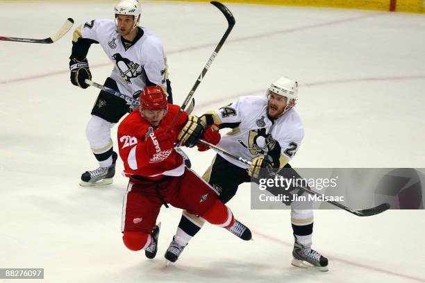 Matt Cooke of the Pittsburgh Penguins collides with Jiri Hudler of the Detroit Red Wings during Game Five of the 2009 NHL Stanley Cup Finals at Joe...