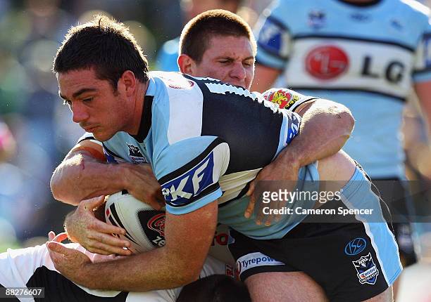 Grant Millington of the Sharks is tackled during the round 13 NRL match between the Cronulla-Sutherland Sharks and the Warriors at Toyota Stadium on...