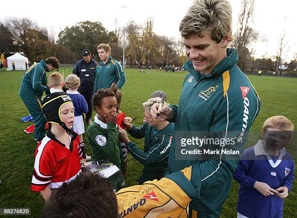 Berrick Barnes of the Wallabies signs apparel during an Australian Rugby Union fan day at Griffith Oval on June 7, 2009 in Canberra, Australia.