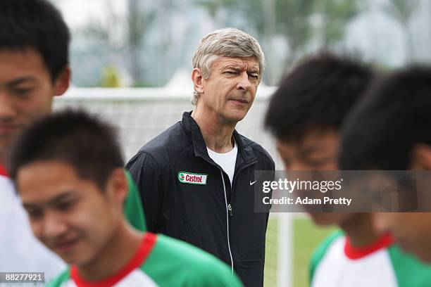 Arsene Wenger takes the Chinese National youth team through the Castrol Challenge at the Birds Nest Stadium during his tour of Asia with FIFA World...