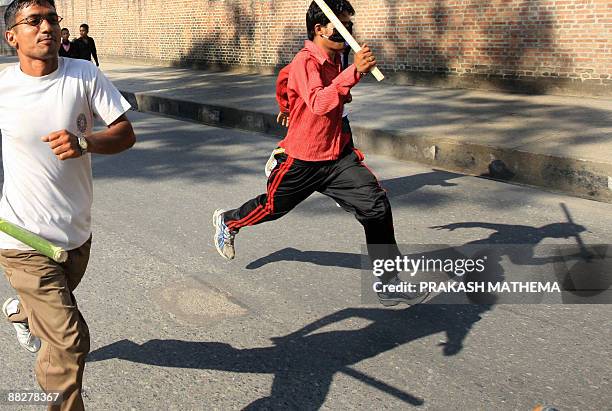 Supporters of the Unified Communist Party of Nepal carry sticks as they take out a protest rally against the Nepalese president and the government in...