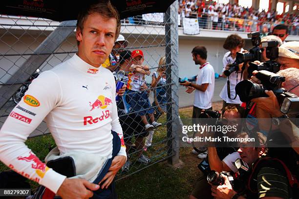 Sebastian Vettel of Germany and Red Bull Racing is surrounded by photographers on the grid before the start of Turkish Formula One Grand Prix at...