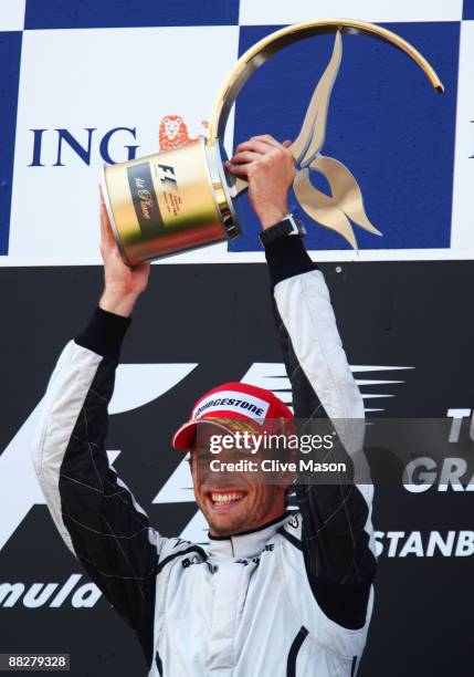 Jenson Button of Great Britain and Brawn GP celebrates on the podium after winning the Turkish Formula One Grand Prix at Istanbul Park on June 7 in...