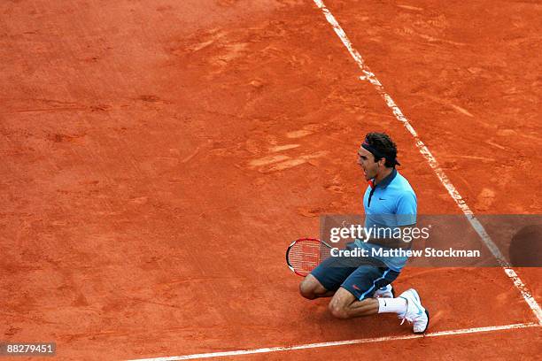 Roger Federer of Switzerland falls to his knees as he celebrates victory during the Men's Singles Final match against Robin Soderling of Sweden on...