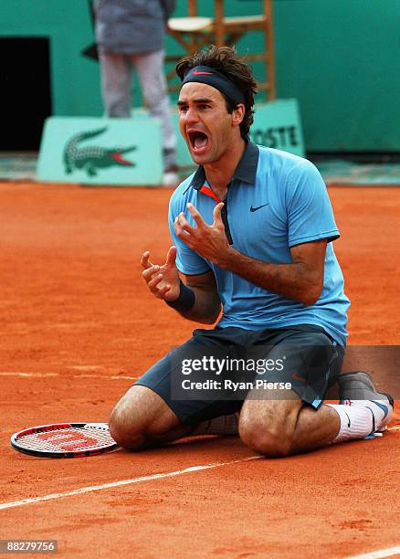 Roger Federer of Switzerland falls to his knees as he celebrates victory during the Men's Singles Final match against Robin Soderling of Sweden on...