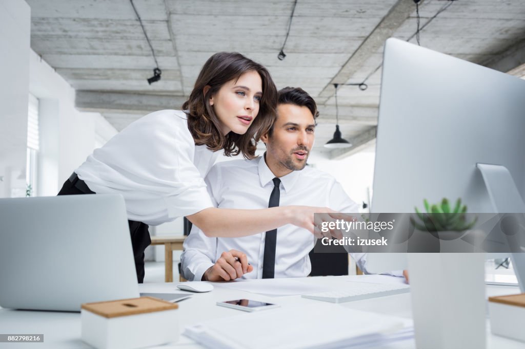 Business people working together on computer