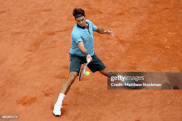 Roger Federer of Switzerland hits a forehand during the Men's Singles Final match against Robin Soderling of Sweden on day fifteen of the French Open...